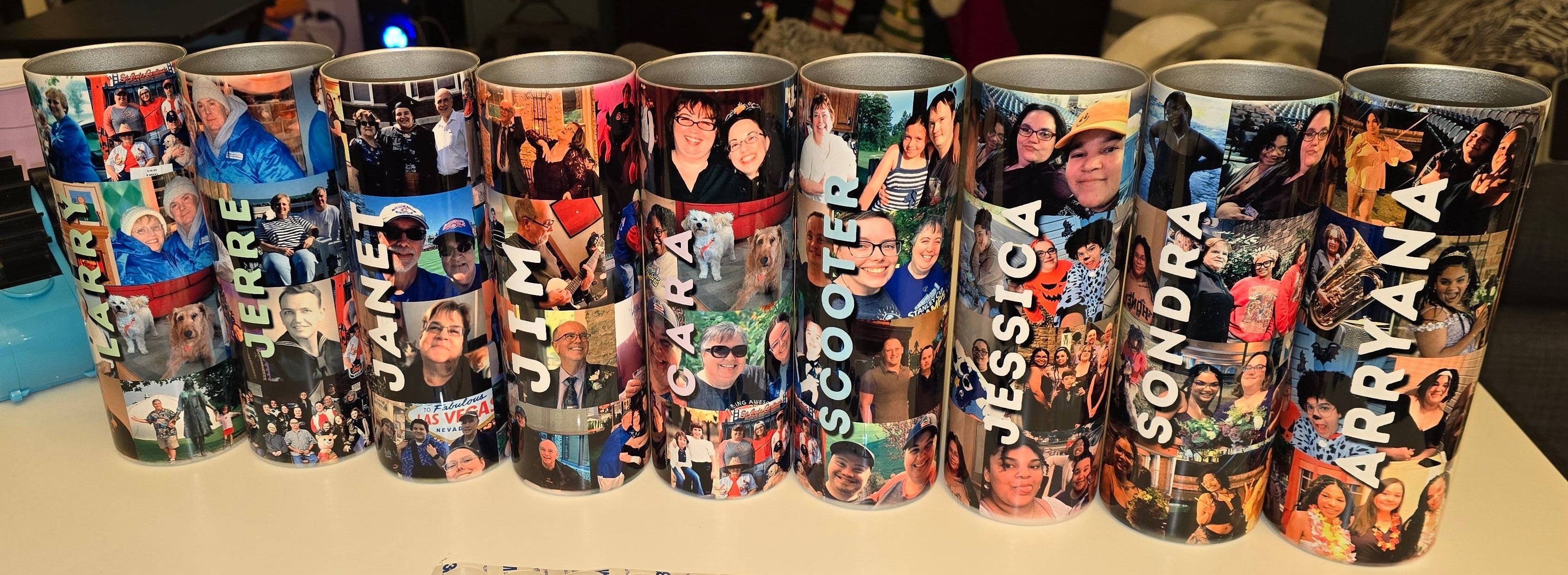 Row of personalized tumblers with various images on a table in a room setting.